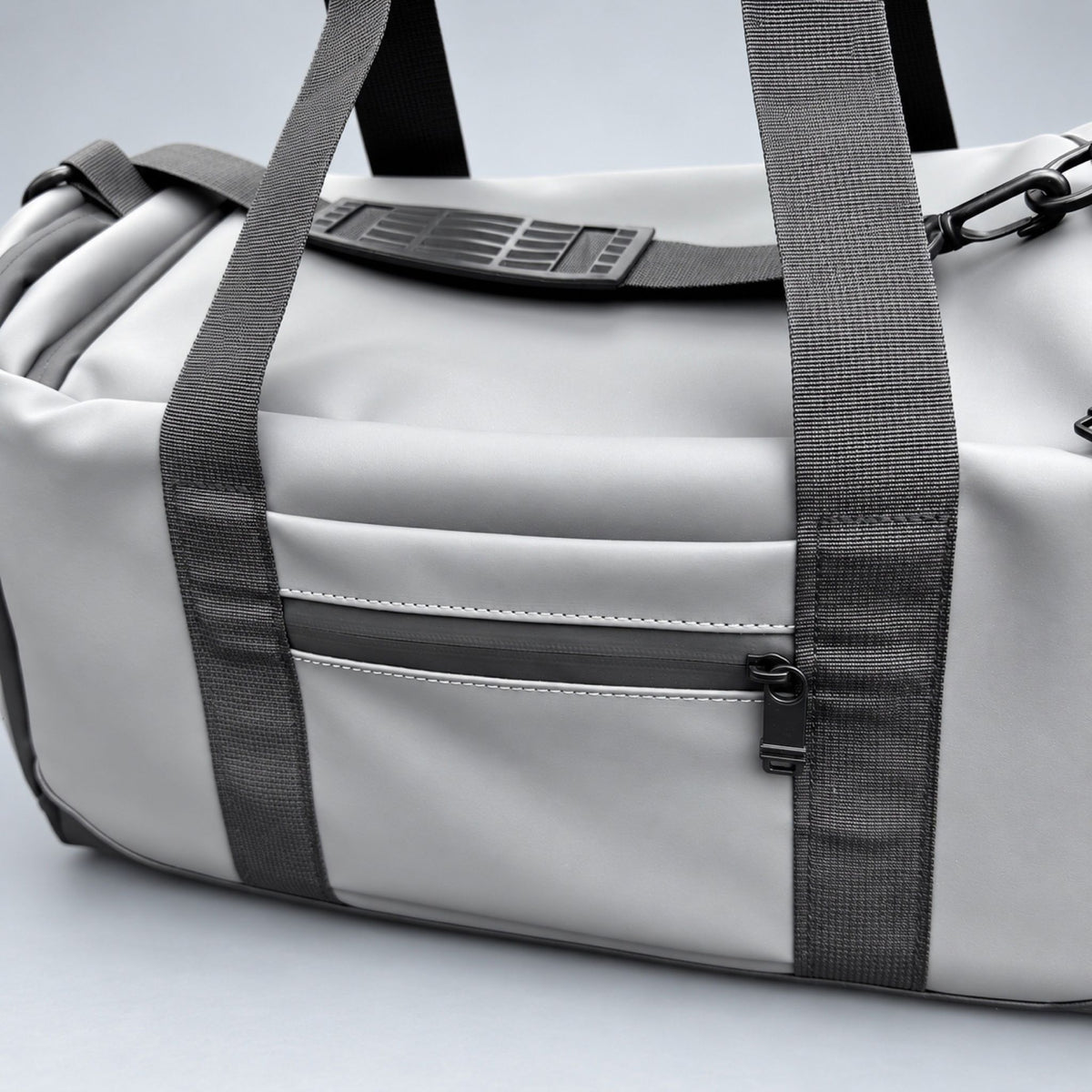 Grey Transit duffle bag passport and phone pocket close-up #Colour_Grey